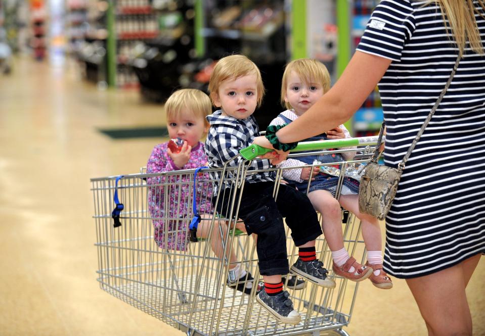  Toddlers Niamh, Aoifa and Cormac look comfortable in their special trolley.