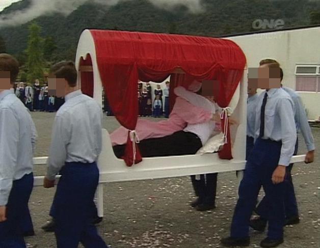  A couple are carried along in what looks like a wedding procession