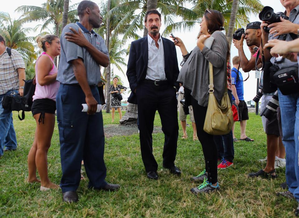  McAfee speaks with media after arriving back in the US in 2012 having spent several weeks on the run