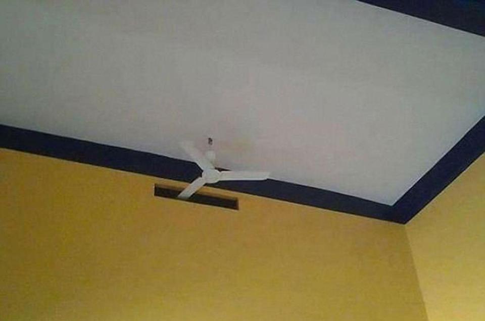  Builders apparently had to carve a slot in the wall to let this poorly placed fan turn