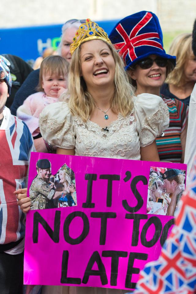 Victoria McRae poses with her sign - telling Prince Harry it's not to late to marry her