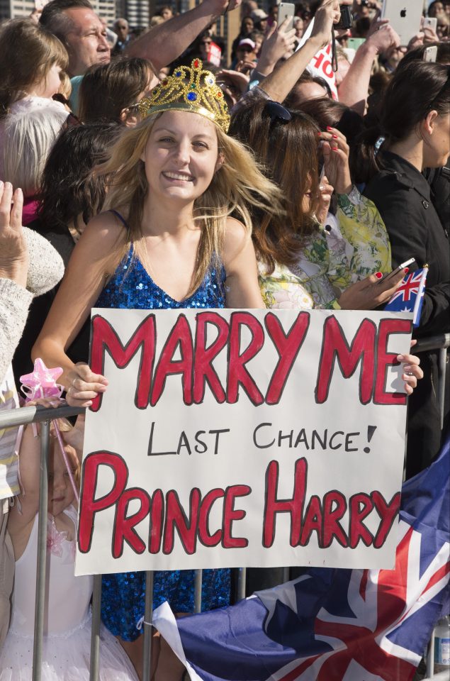 Victoria McRae poses with a sign, saying it's Prince Harry's 'last chance' to marry her