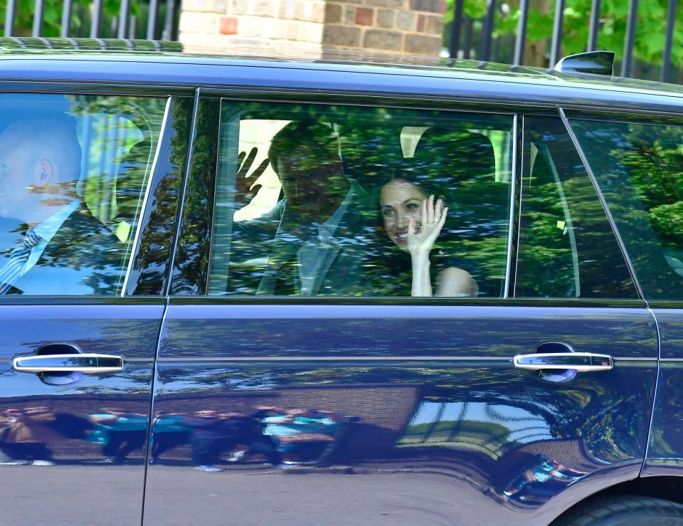  The couple beam as they are driven away from Kensington Palace today