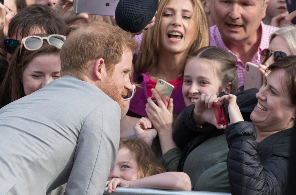  Prince Harry leans in for a quick photo and looks carefree and relaxed with royal fans