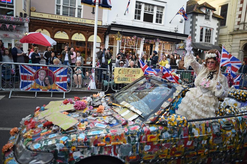  Jubilant well-wisher waves from an elaborately decorated car ahead of the Royal Wedding