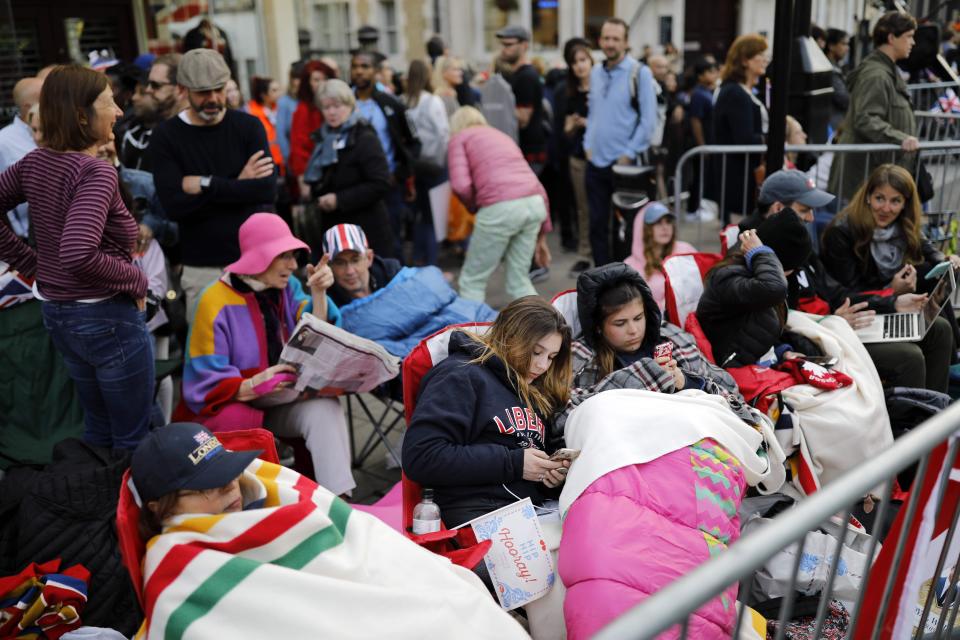  Royal well-wishers cosy up with sleeping bags, blankets and warm coats as they hunt for the best spot to watch the royal procession