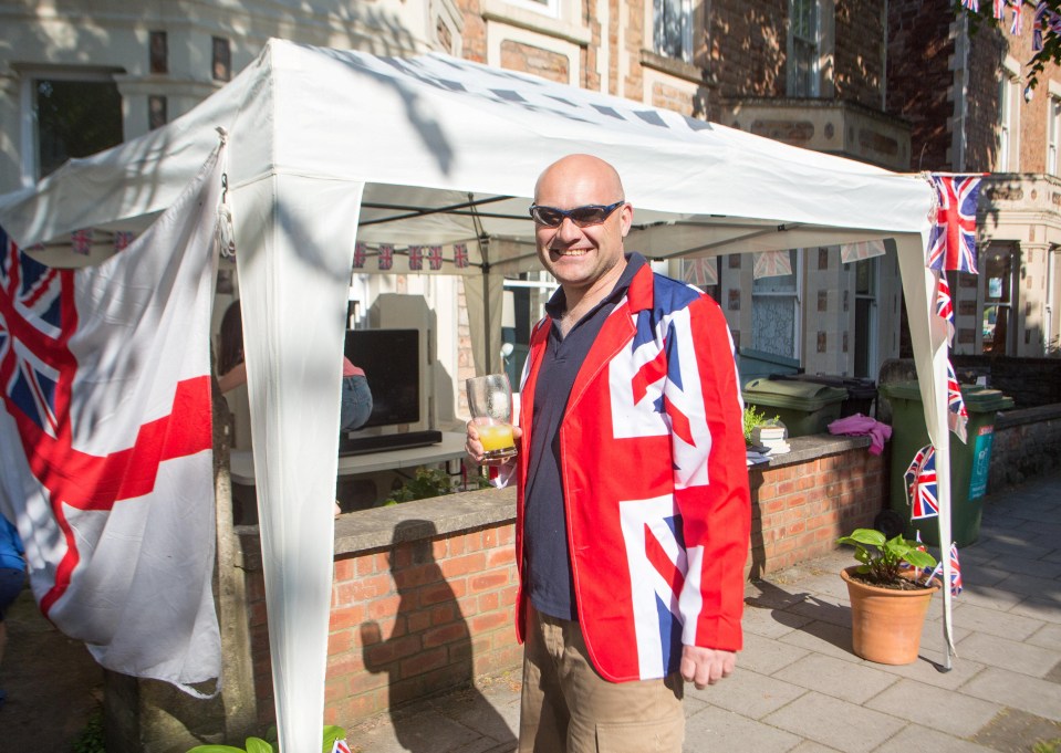 Paul Snellings prepares for a royal wedding street party in Bristol wearing his Union Jack best