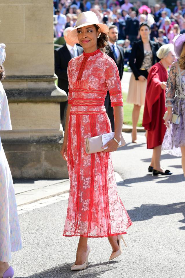  Suits actress Gina Torres looked elegant in this stunning red gown with a nude clutch bag