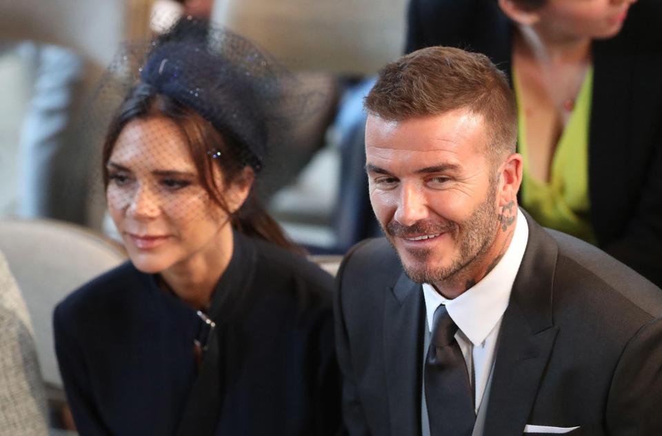  Victoria Beckham was spotted finally cracking a smile during the Royal Wedding