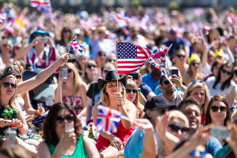 A woman in a cowboy hat waves an American flag, as the two countries come together with the marriage of Prince Harry and Meghan