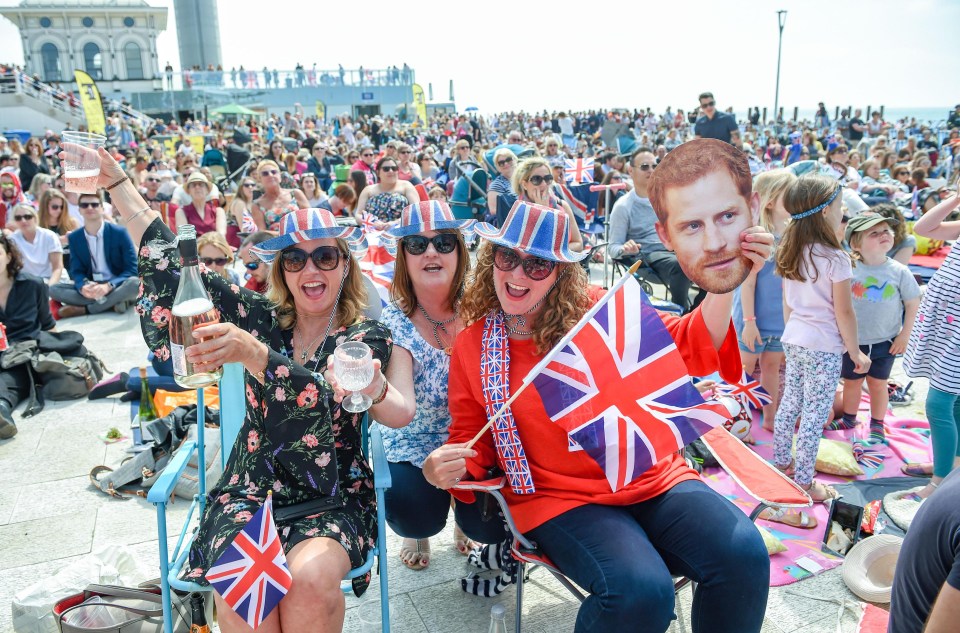 Thousands on Brighton beach watch the Royal wedding on a giant screen erected on Brighton seafront