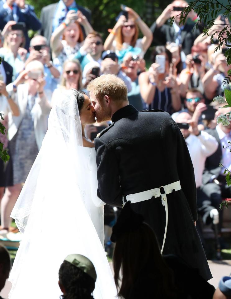  The crowd burst into a round of applause as Meghan and Harry kissed