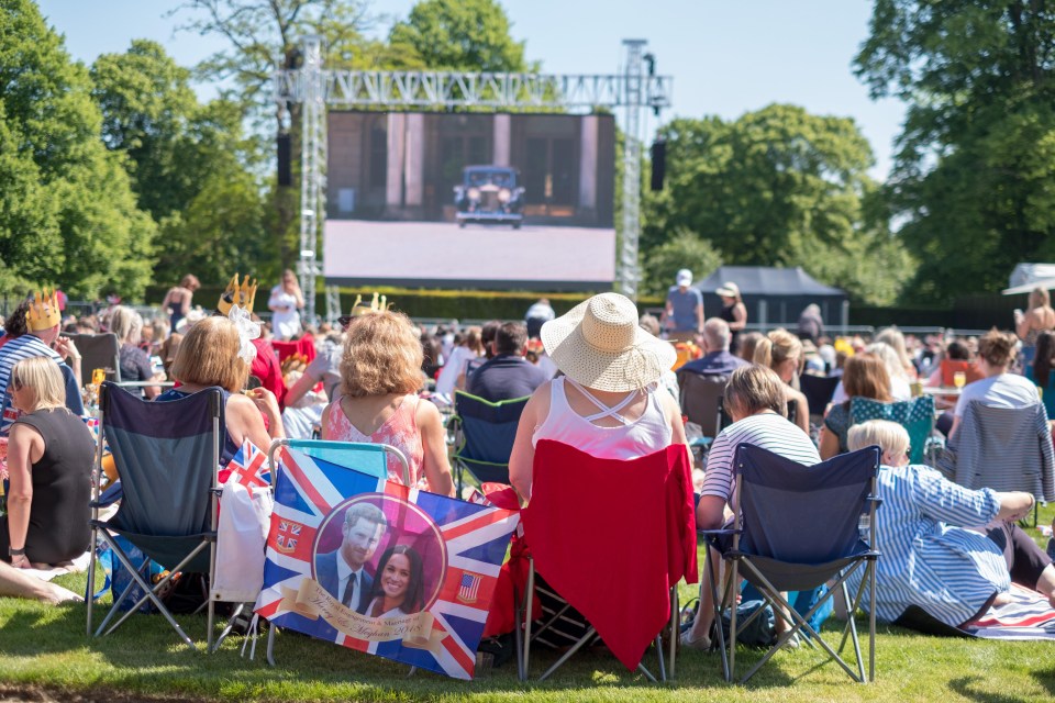 Crowds gathered in the gardens of Kensington Palace to watch the wedding at a special screening