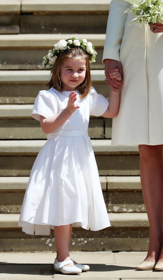  Princess Charlotte threatens to steal the show as she waves at cheering crowds