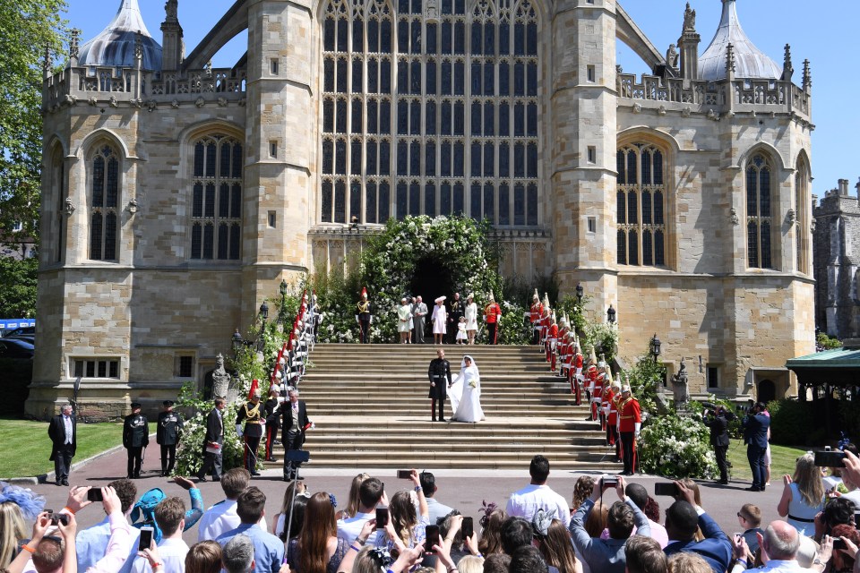 Harry and Meghan stand out the front of Windsor Castle on their wedding day - the same wedding venue Princess Eugenie will tie the knot at in October