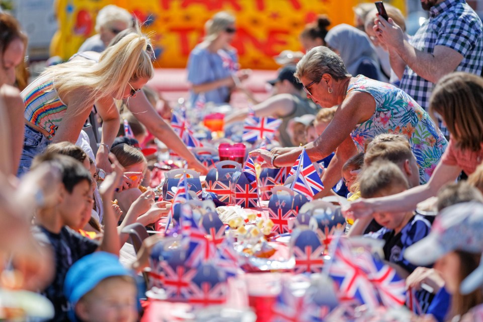 Adults and kids enjoy themselves at a street party in Cardiff