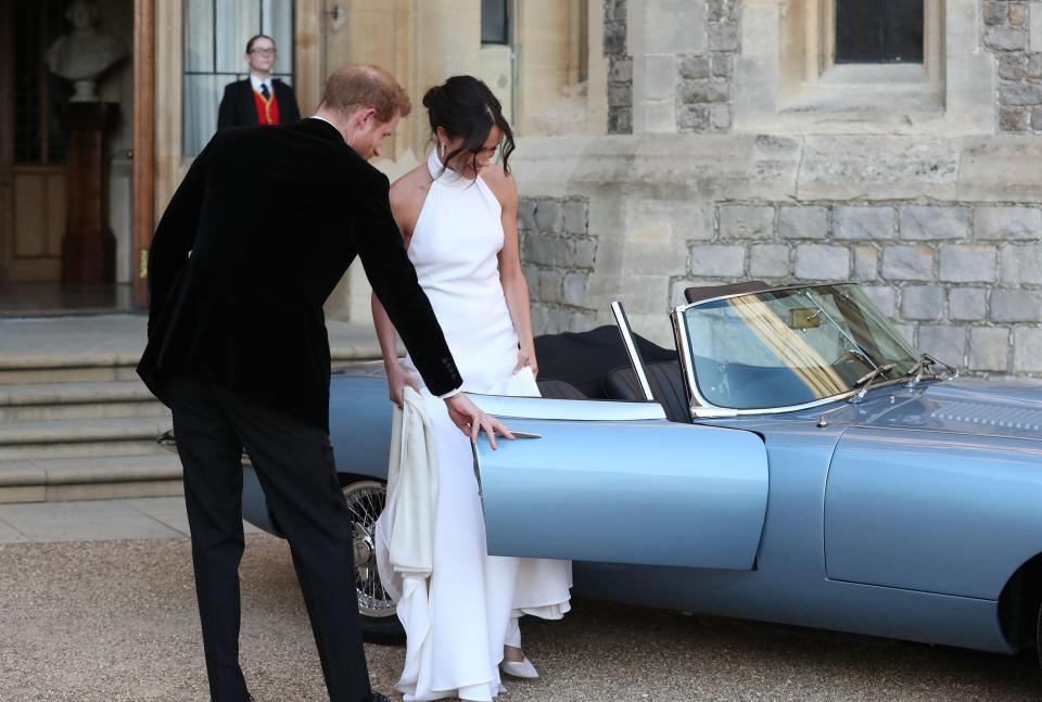  Prince Harry opens the car door for his bride as they leave for their reception last night