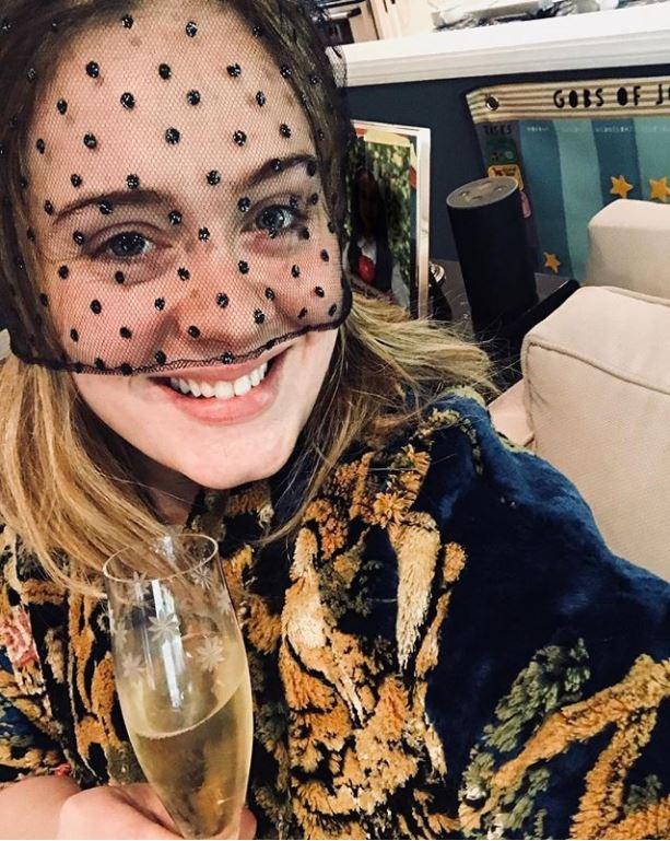  Adele took to Instagram to share a snap of her with a glass of fizz as she toasted the happy couple