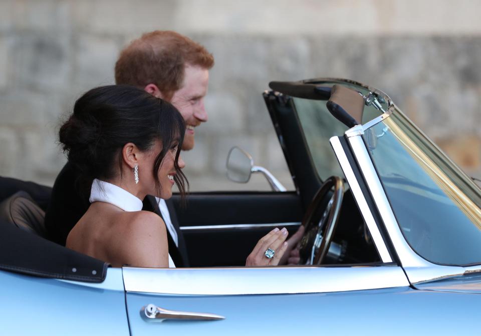  The newlyweds look like Hollywood stars in their open top convertible. Meghan is wearing an emerald cut aquamarine diamond which once belonged to Princess Diana