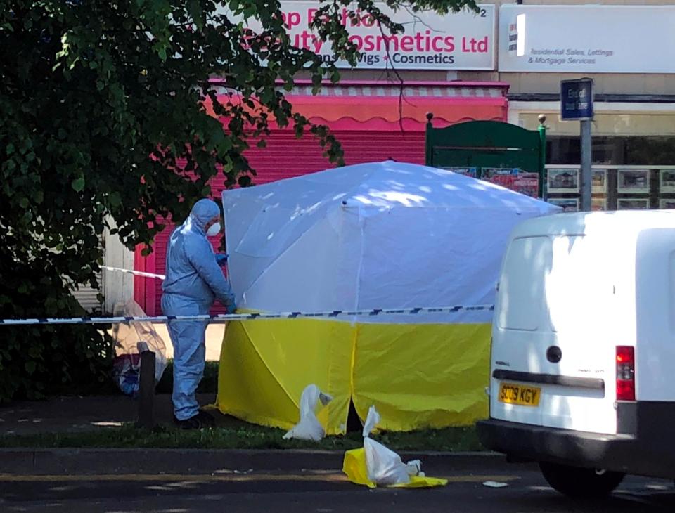  Forensics cops work at the scene of the stabbing in South London today