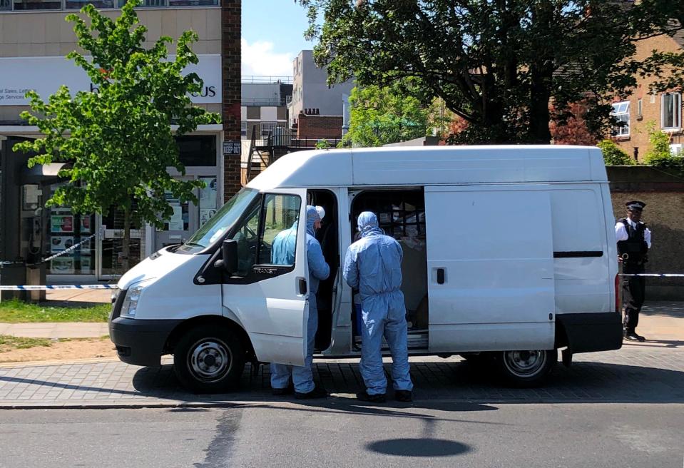  Forensics officers work at the scene of the fatal stabbing in South London