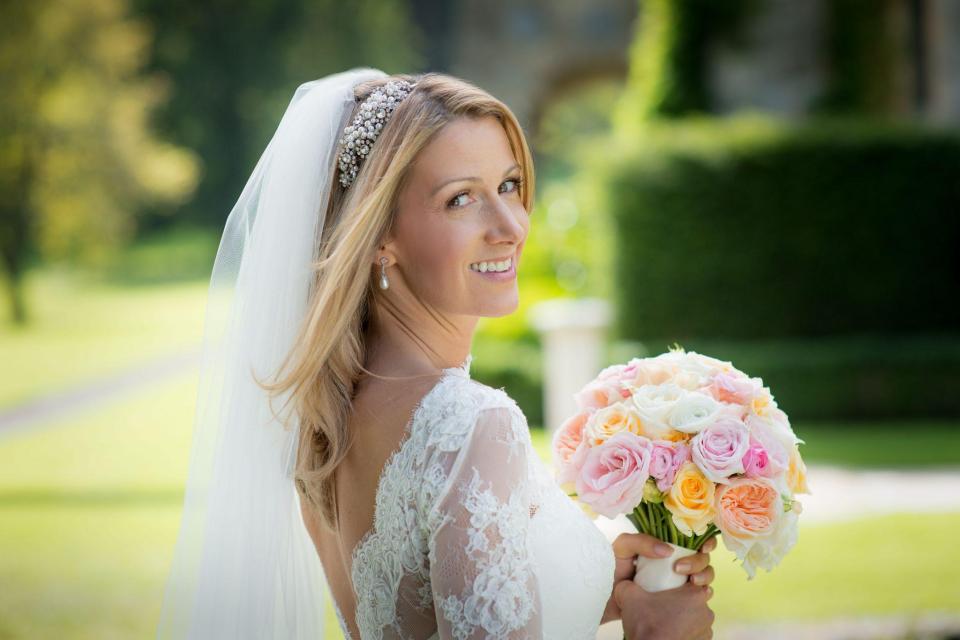  Rachael beams as she poses for a photo on her wedding day