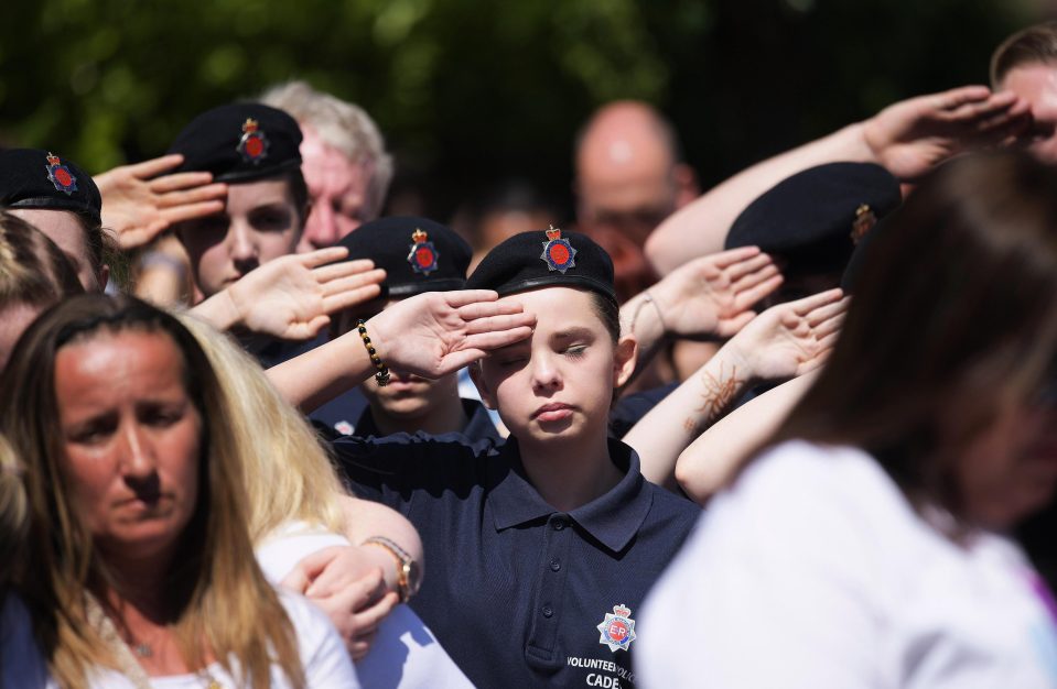  A young cadet salutes in Manchester as the country observes the minute silence