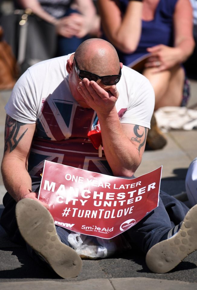  A man wipes away a tear on the first anniversary of the atrocity