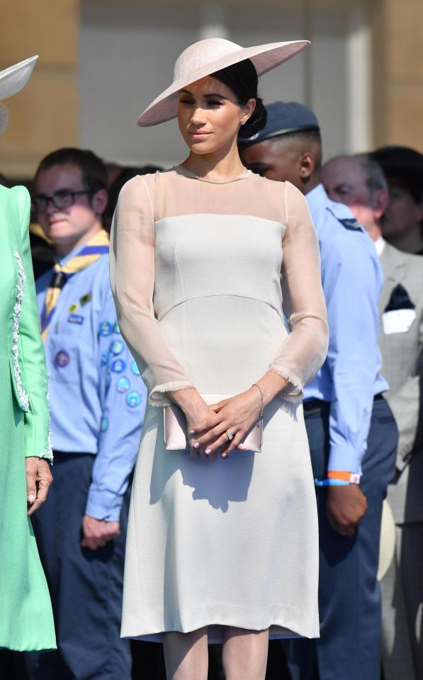  Meghan accessorised her outfit with a clutch bag and matching hat