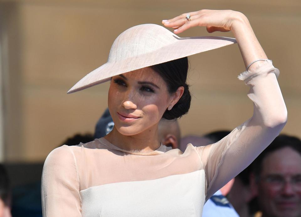  Meghan kept her make-up simple with a nude lip and delicate smokey eye