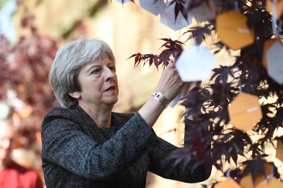  Theresa May joined others in leaving a message on a memorial tree