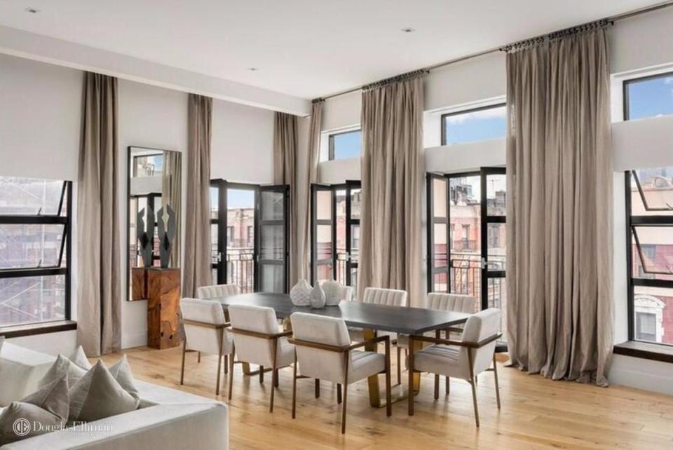  Wooden flooring, exposed brick and ceiling-to-floor windows are just some of the apartment's stunning features