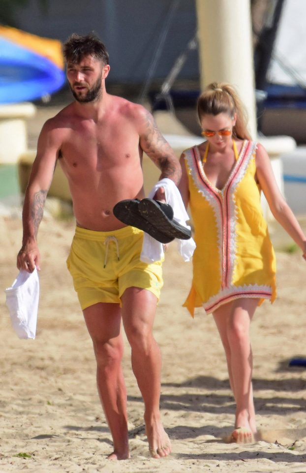  Charlie Austin walks hand-in-hand along the beach with wife Bianca