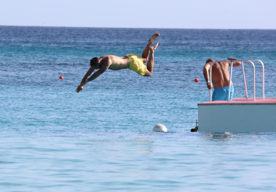  Charlie Austin jumps around in the ocean while in Barbados