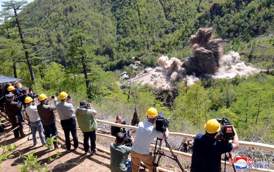  Photographers and film crews record the destruction