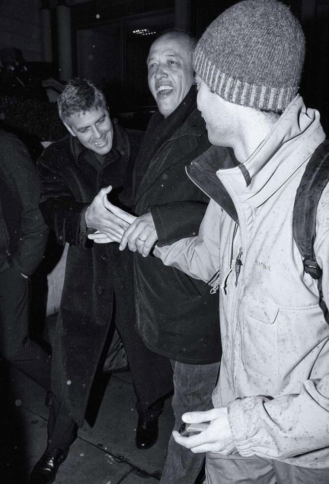  George Clooney seemed to shake someone's hand and smiled during a night out in the capital