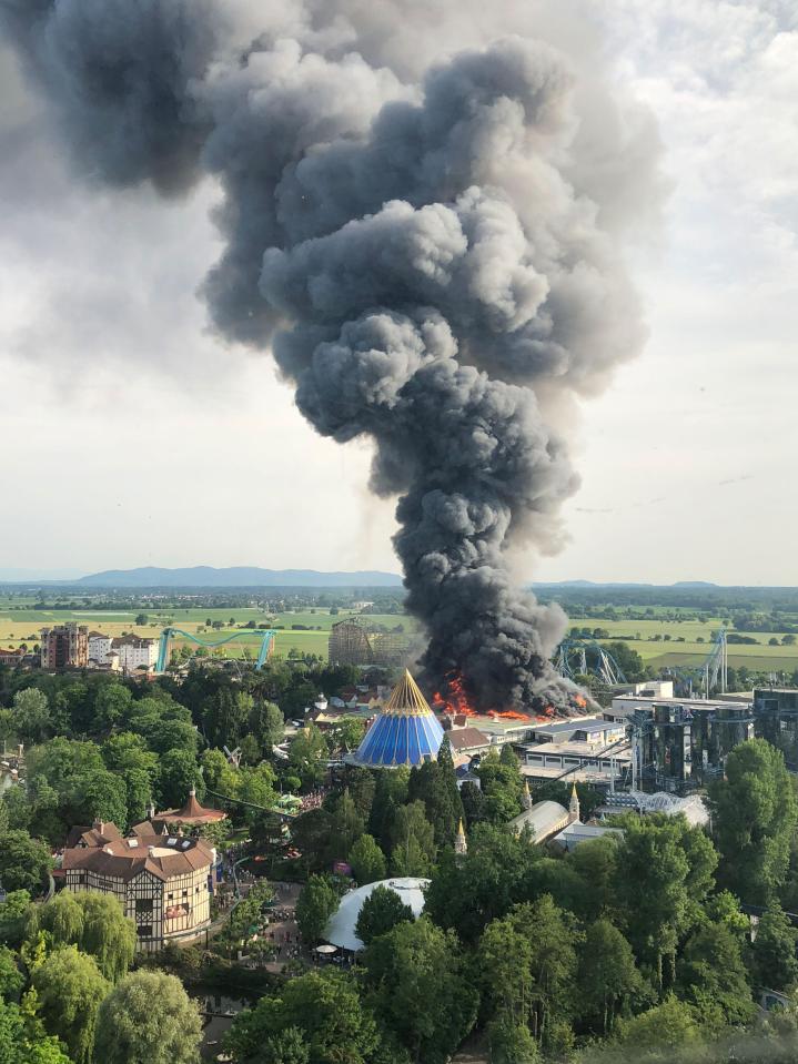  Black smoke billows into the sky above Europa-Park as a fire rages out of control