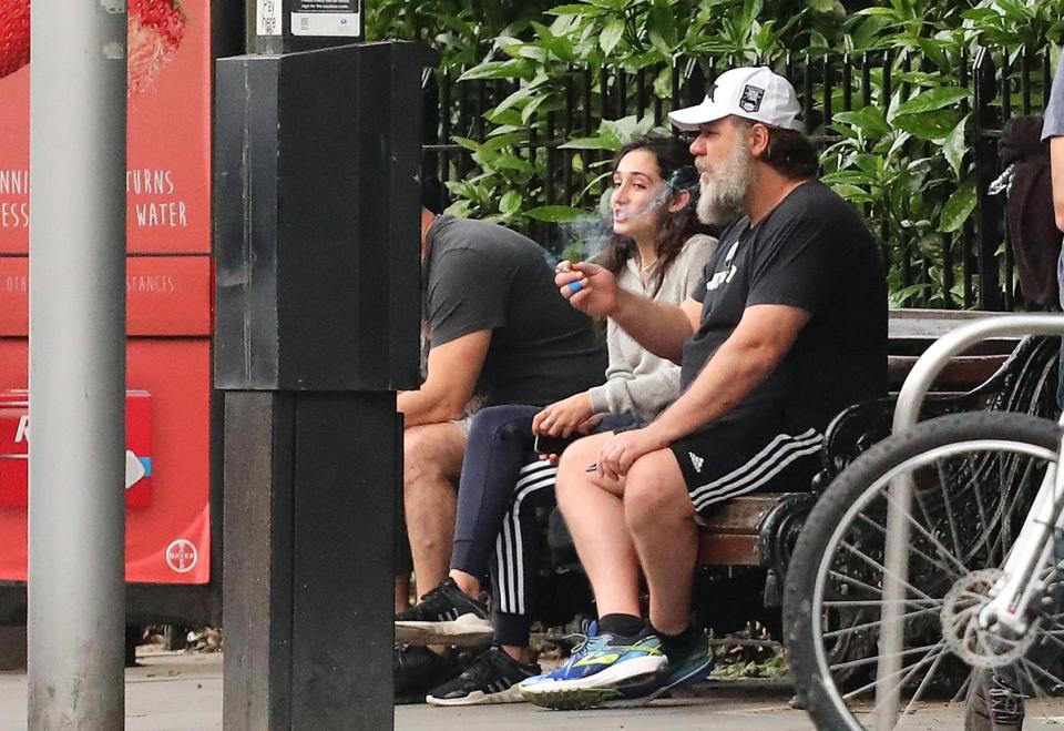  Crowe was seen puffing on a cigarette as he sat alongside his employee on a park bench