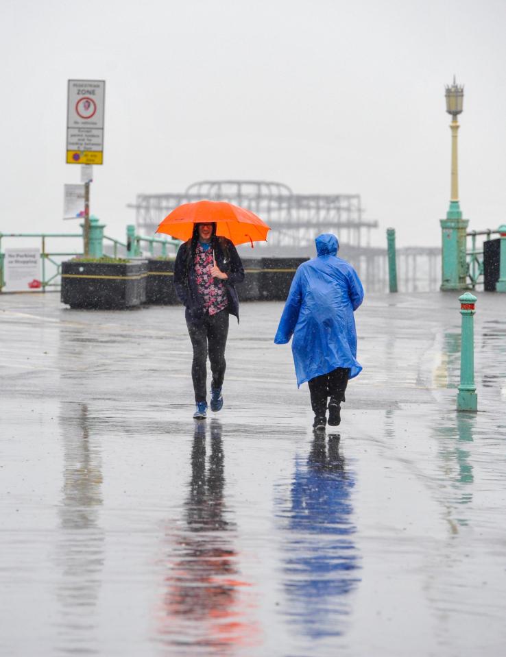  Brits were hit with torrential rain on the Brighton seafront on Thursday - with the weather conditions predicted to only worsen