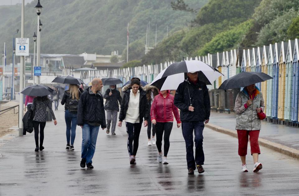  People have braved the deluge of rain as they walk through the wet in Bournemouth