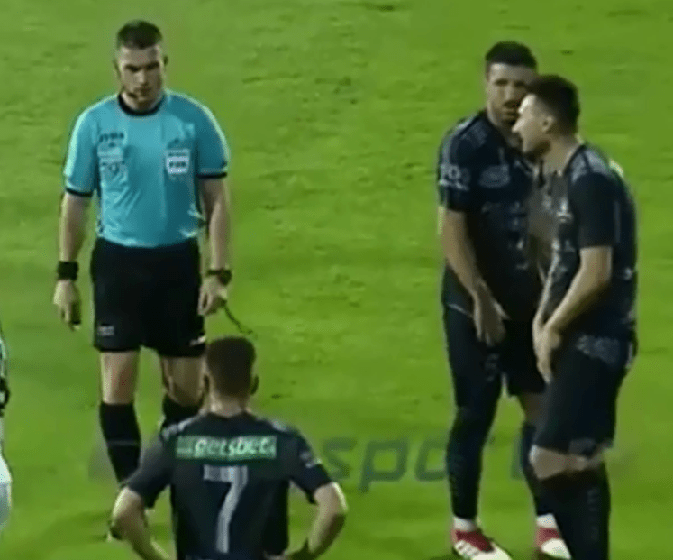 Referee Istvan Kovacs marches over after blowing for a free-kick