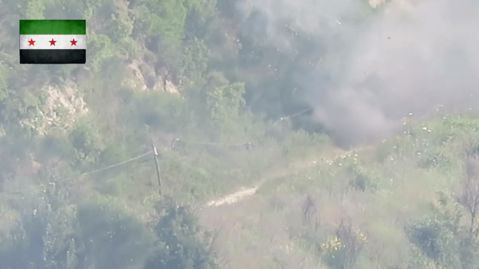  Plumes of grey smoke appear after the missile hits the ground and explodes