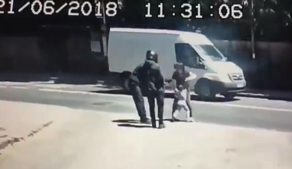  Two men approach a mum and child as they walk down the street in Richmond