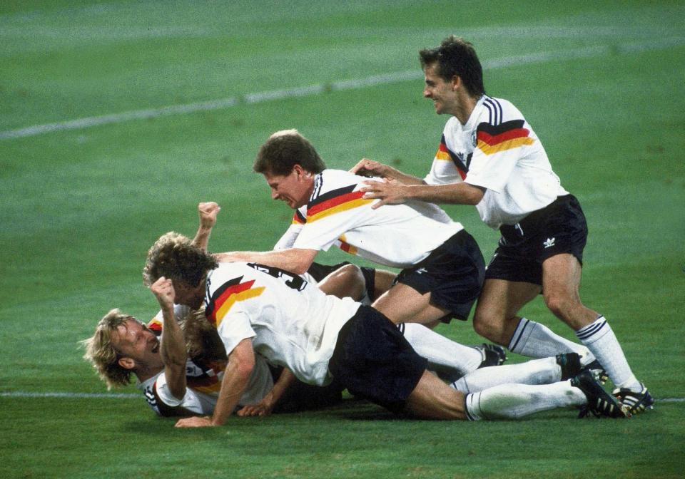  After scoring, Andreas Brehme is mobbed by his West German teammates