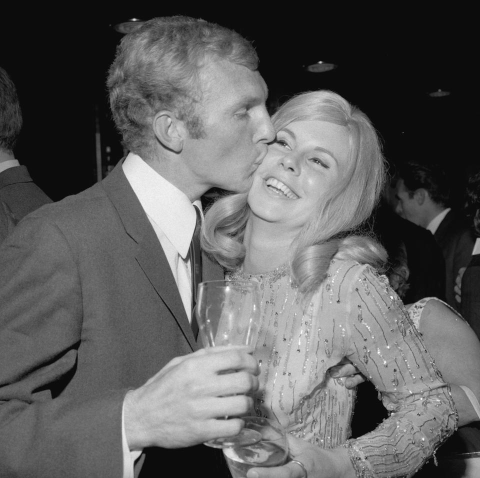  Bobby Moore kisses his wife Tina at a reception for the winning England team in July 1966