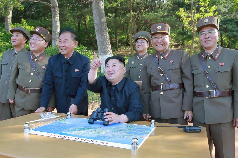 Kim Jong-un smirks as he watches a ballistic missile launch in July last year