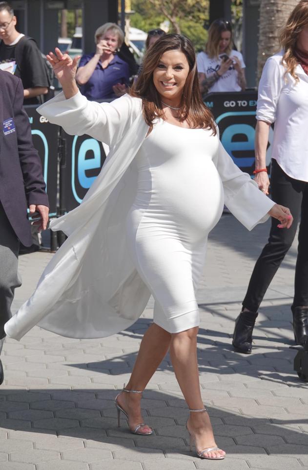  Eva shows off her baby bump in this all white outfit