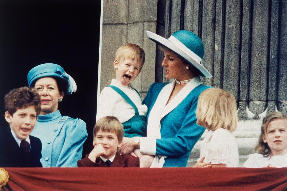  Prince Harry pokes his tongue out as he is held by mum Princess Diana