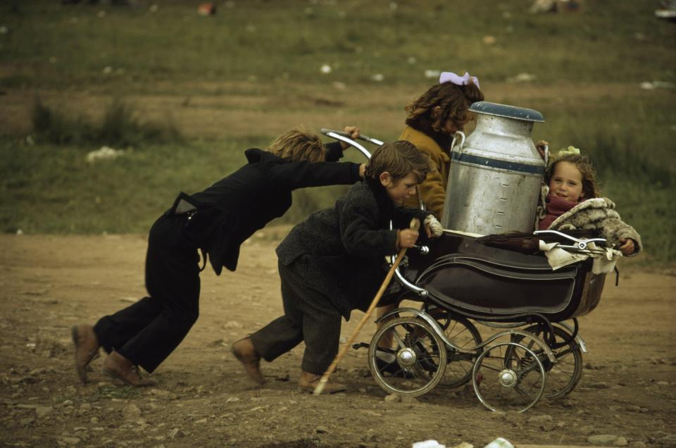  Starting them young! Kids push their belongings across the fields of Appleby in Cumbria ready for a fair in the 1970s