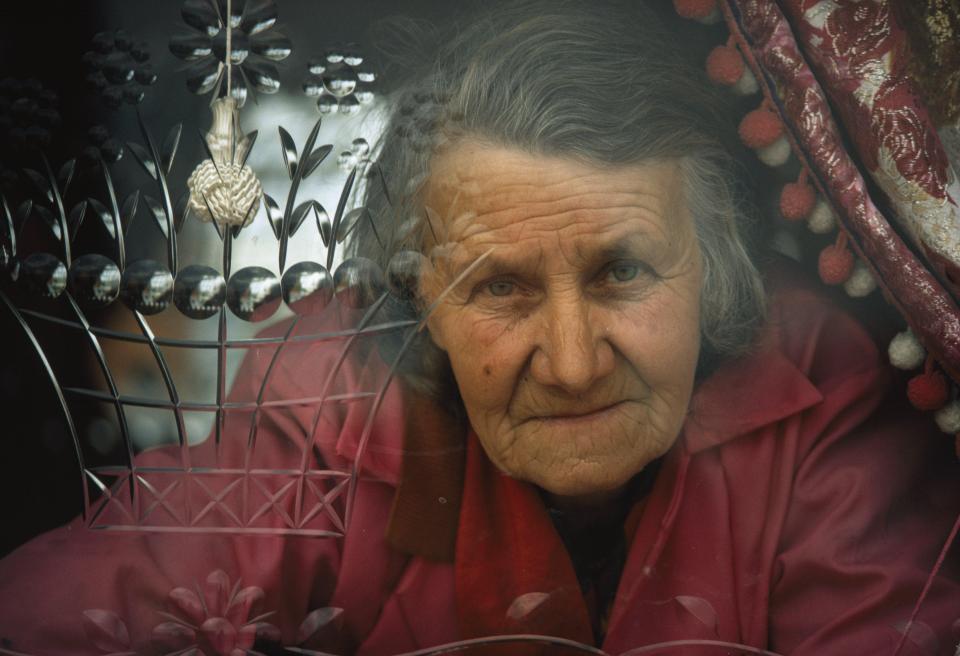  An elderly traveller peers through the ornately etched window of her motor home in Appleby in the 1970s